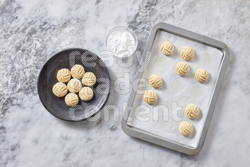 Kahk step by step with its ingredients ghee, sugar, flour, sesame, yeast, water and kahk flavor on grey marble background