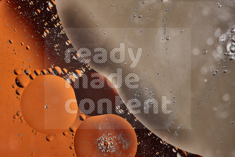 Close-ups of abstract oil bubbles on water surface in shades of orange and brown