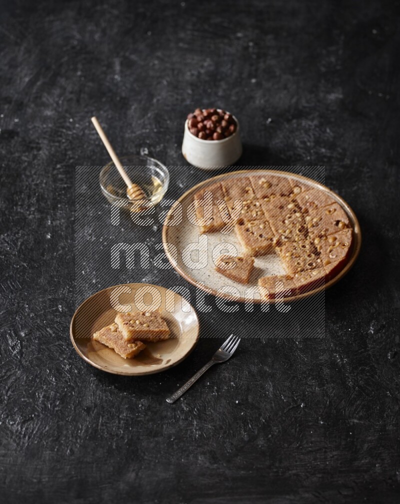 Basbousa with nuts and honey in a dark setup