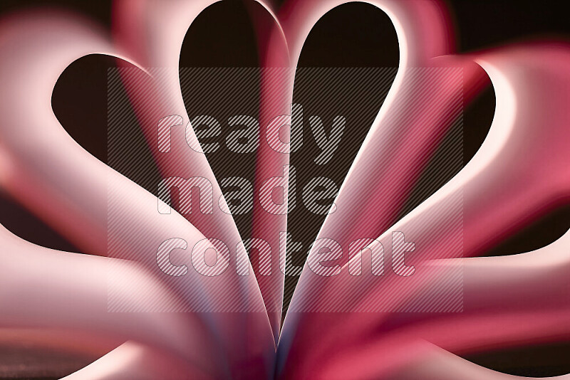 An abstract art piece displaying smooth curves in white and pink gradients created by colored light