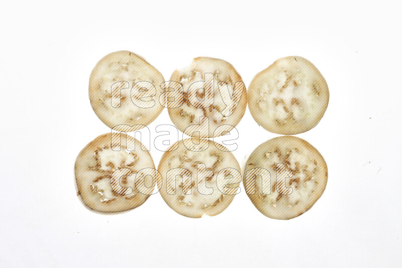 Eggplant slices on illuminated white background