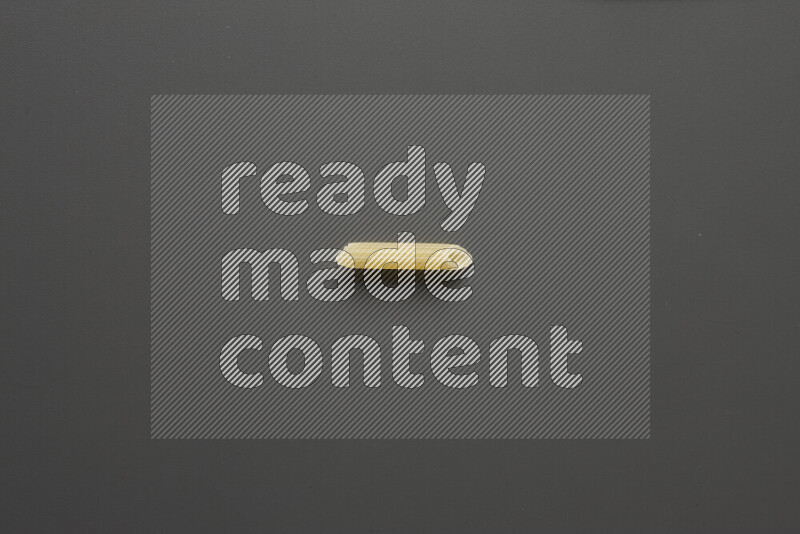 Mini penne pasta on grey background