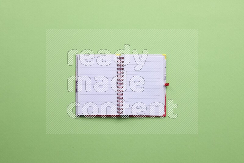 A blank open notebook on green background