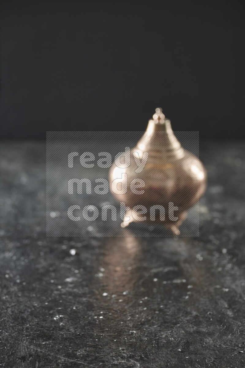 An out of focus lantern on textured black background