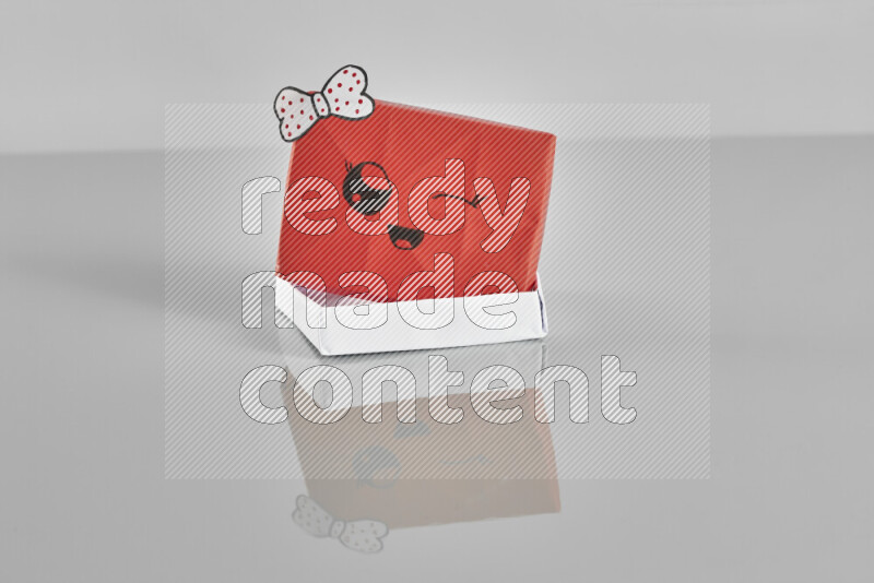 Origami gift box on grey background
