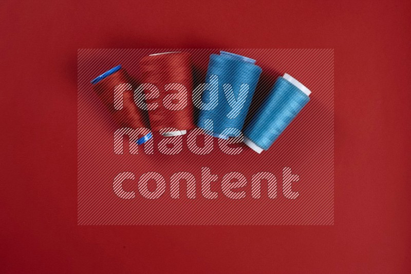 Blue sewing supplies on red background