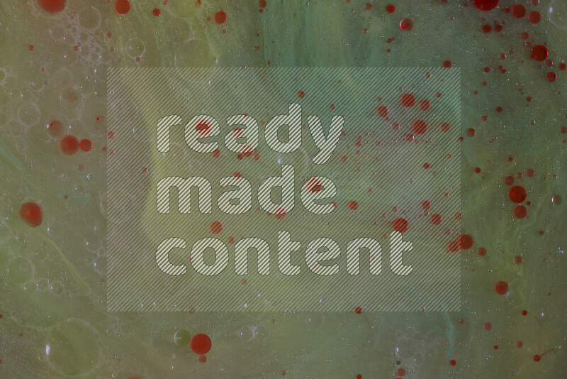 تلتقط الصورة تناثرا للطلاء الأحمر علي خلفية خضراء