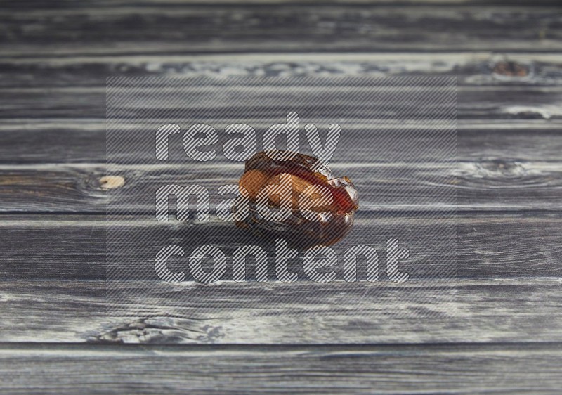 almond stuffed madjoul date on a wooden grey background