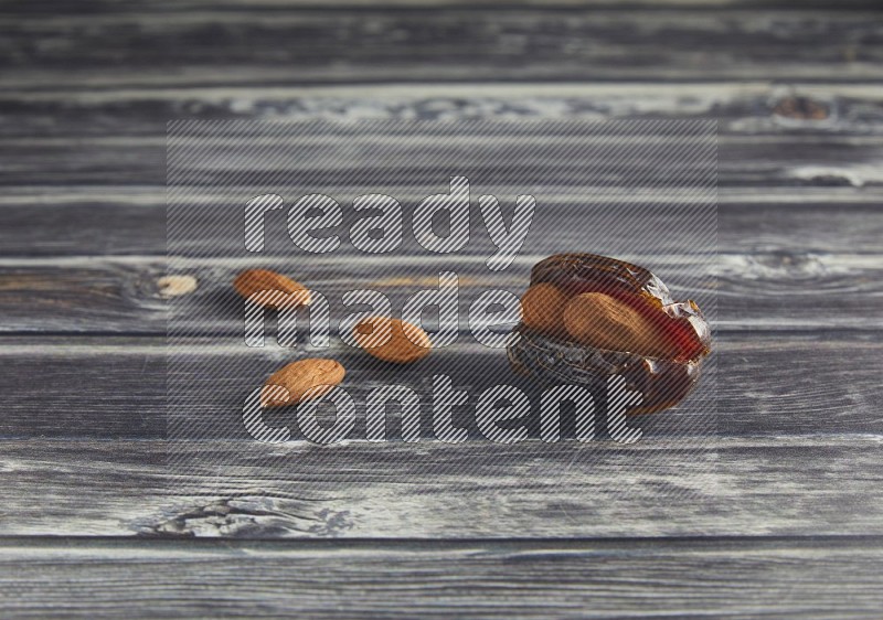 almond stuffed madjoul date on a wooden grey background