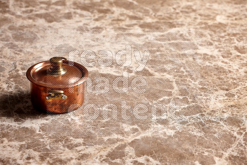 Small Copper Pot on Beige Marble Flooring, 45 degrees