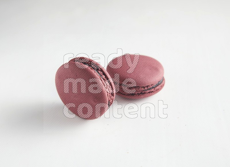 45º Shot of two Red Cherry macarons on white background