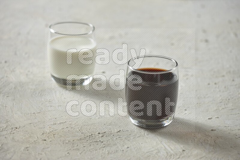 Cold drinks in a glass cup such as water, tamarind, qamar eldin, sobia, milk and hibiscus on textured white background