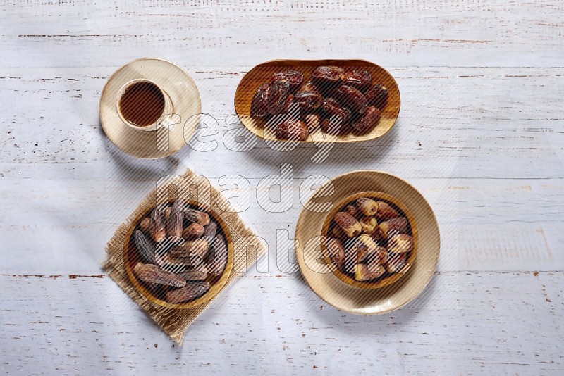 Dates in wooden plates with a drink in a light setups
