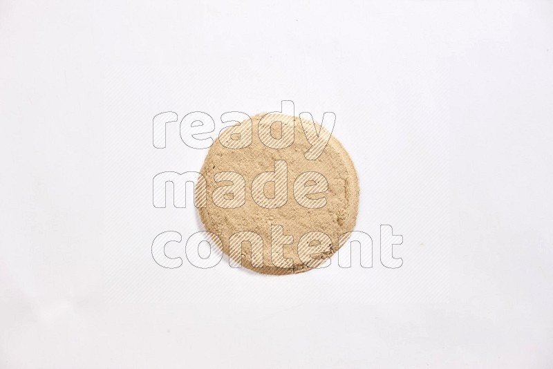 Garlic powder in a circle shape on a white flooring in different angles