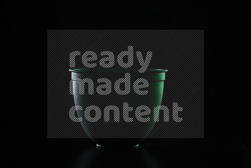 A reflector diffuser lamp shade dish with colored rim light against black background