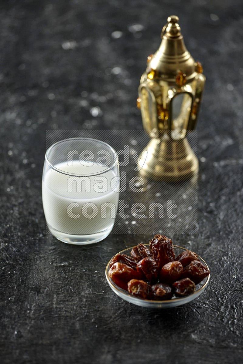 Quran with a prayer beads on textured black background