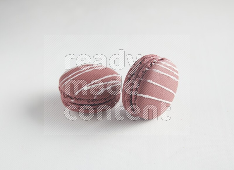 45º Shot of two Red Poppy Flower macarons on white background