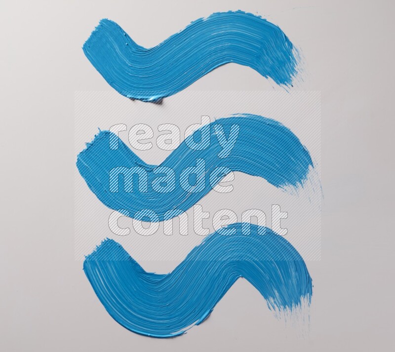 Multi blue curved brush strokes shaped into different shapes on a white background