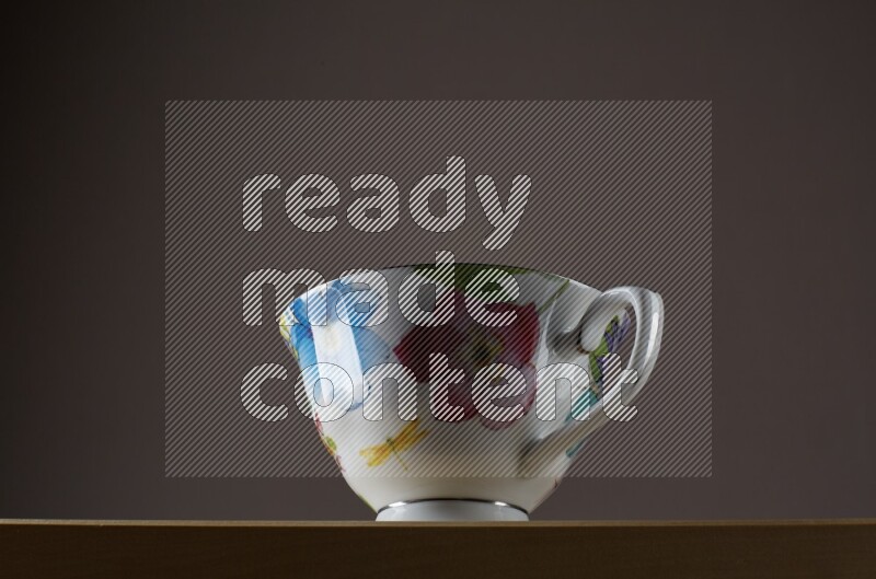 Low angle shot of a decorated cup on grey background