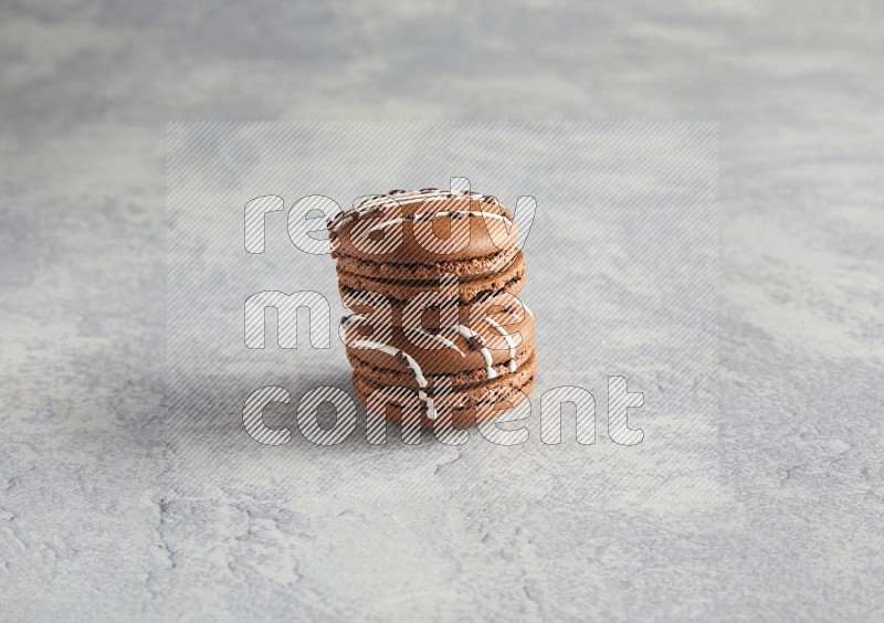 45º Shot of two Brown white marbleChocolate Caramel macarons  on white  marble background