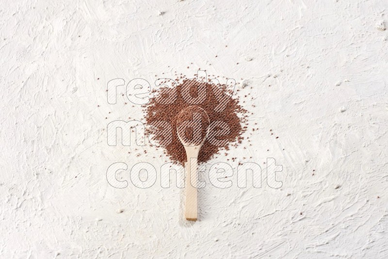 A wooden spoon full of garden cress on a textured white flooring in different angles