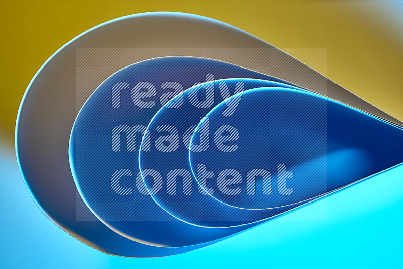 An abstract art of paper folded into smooth curves in blue and yellow gradients