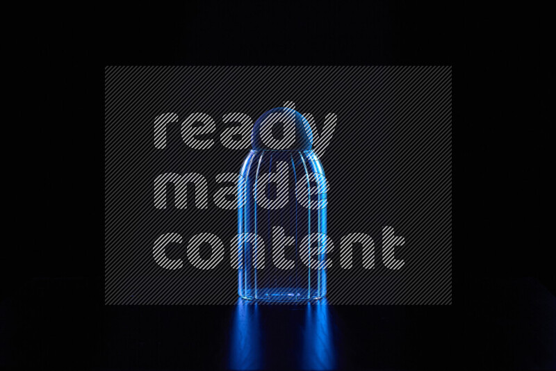 Glassware with rim light in blue against black background