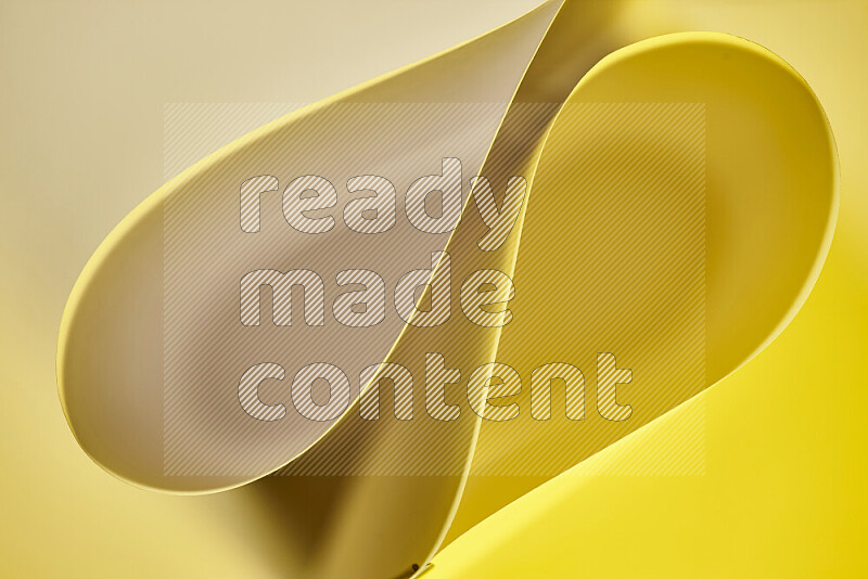 An abstract art of paper folded into smooth curves in yellow gradients