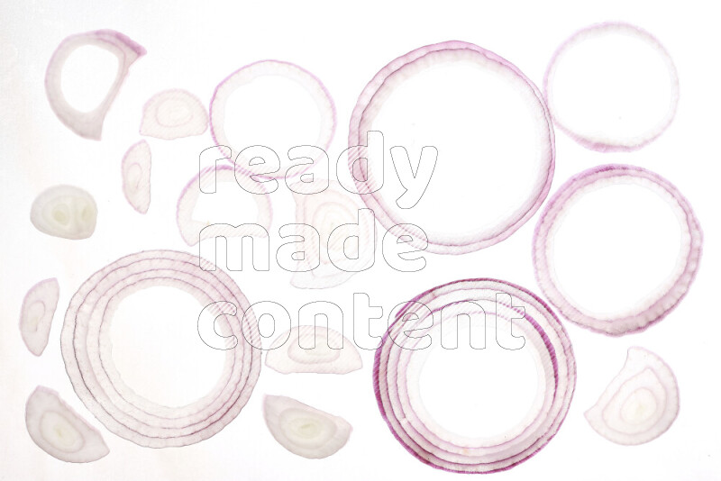 Onion slices on illuminated white background