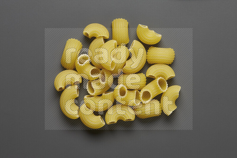 Elbow pasta on grey background