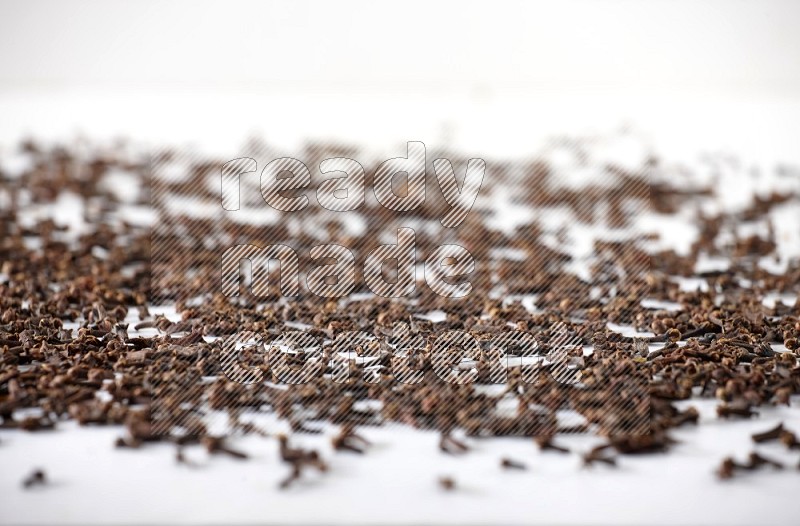 Cloves spread on white flooring