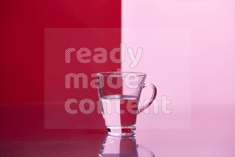 The image features a clear glassware filled with water, set against red and rose background