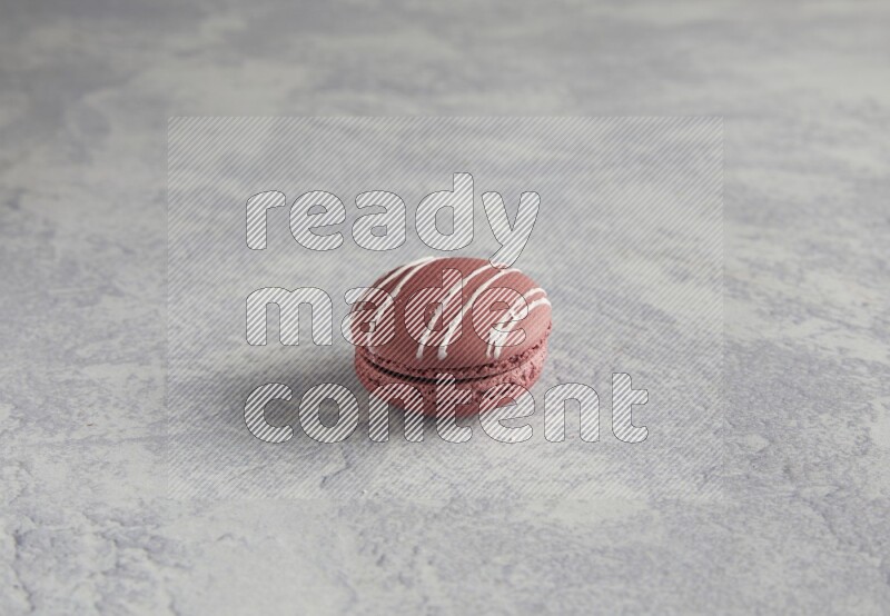 45º Shot of Red Poppy Flower macaron on white  marble background