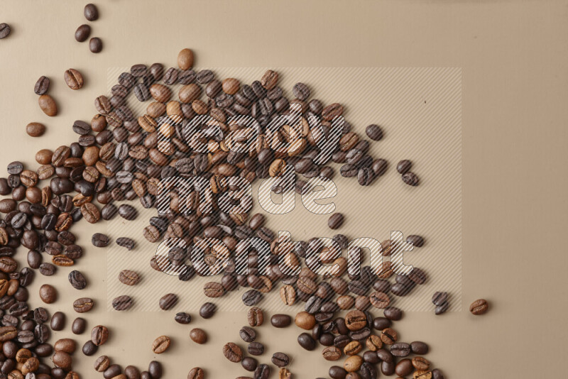 Roasted coffee beans on beige background