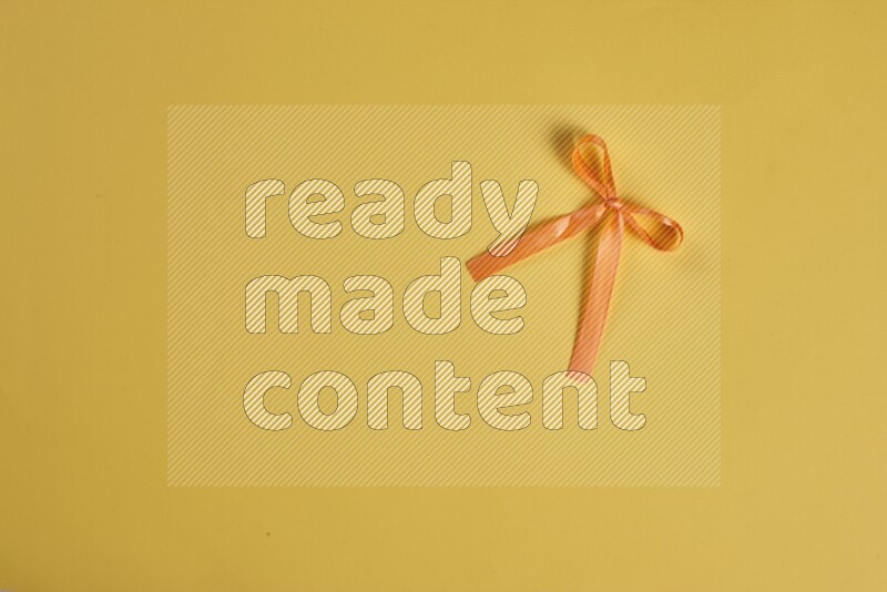 مجموعة من أدوات الخياطة والتفصيل برتقالية اللون على خلفية صفراء