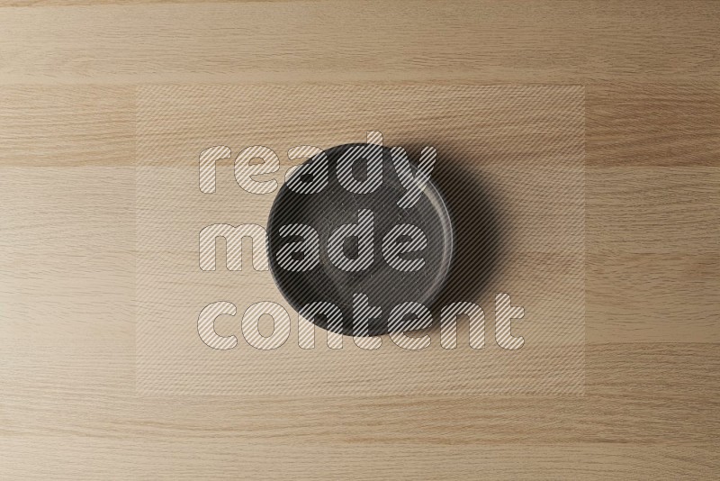 Top View Shot Of A Black Pottery Oven Plate on Oak Wooden Flooring