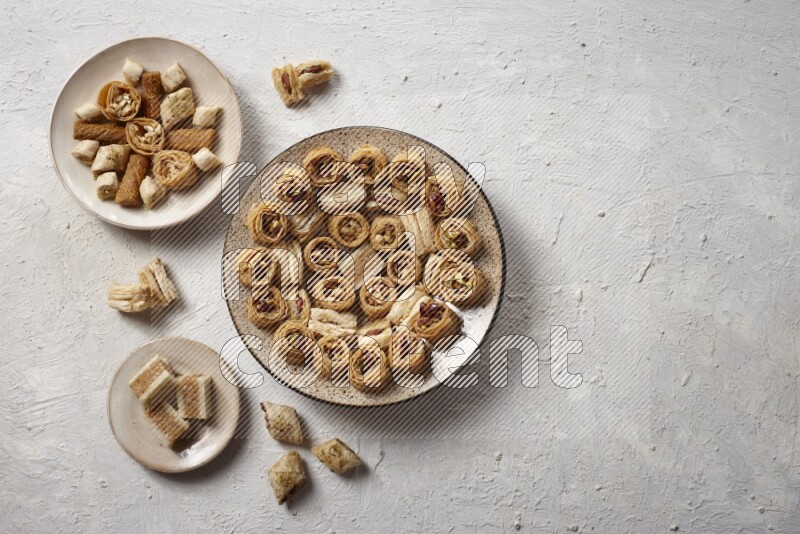 Oriental sweets in pottery plates in a light setup