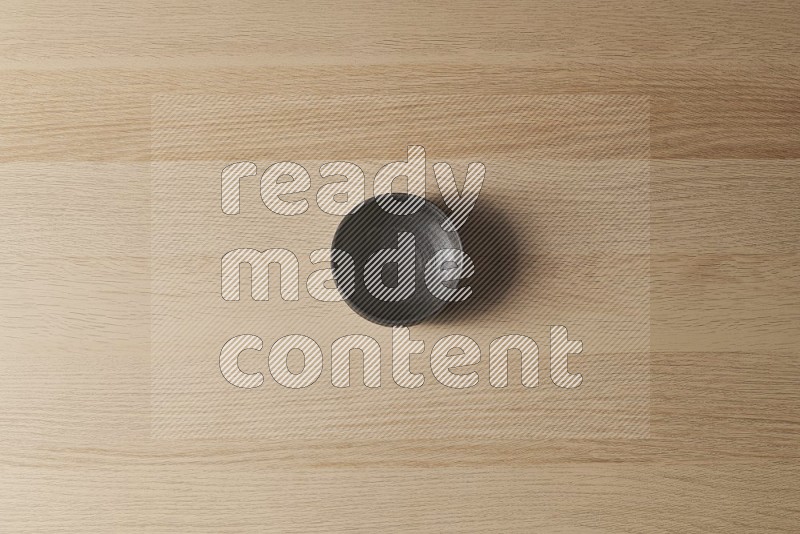 Top View Shot Of A Black Pottery Bowl on Oak Wooden Flooring