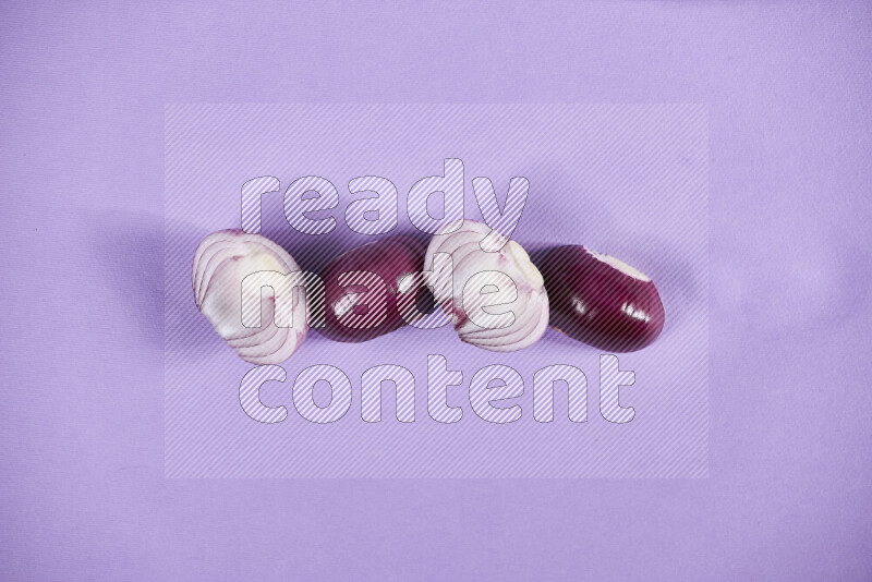 Halves red onions on a purple background