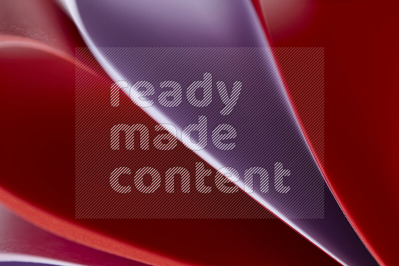 An abstract art showing purple and red paper sheets arranged in an overlapping curves