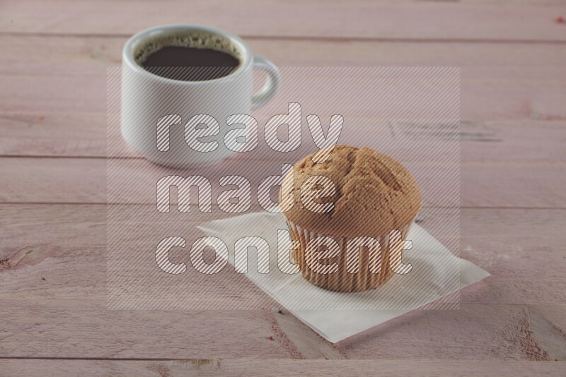 Vanilla cupcake on a wooden pink background