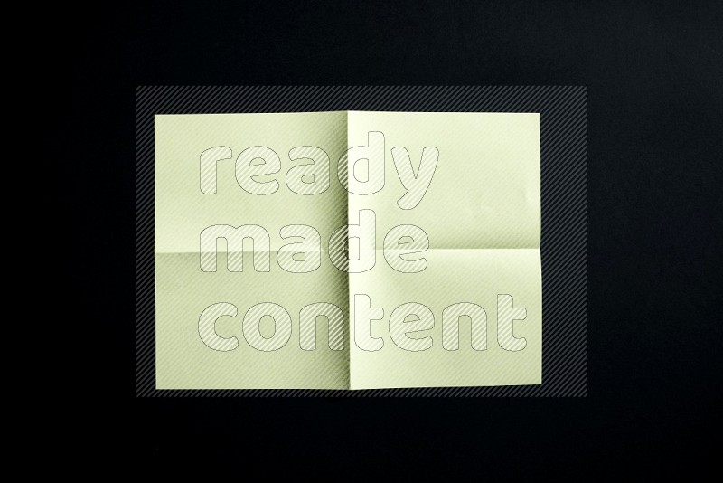 Yellow paper sheet on black background