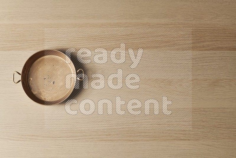 Top View Shot Of A Small Copper Pan on Oak Wooden Flooring