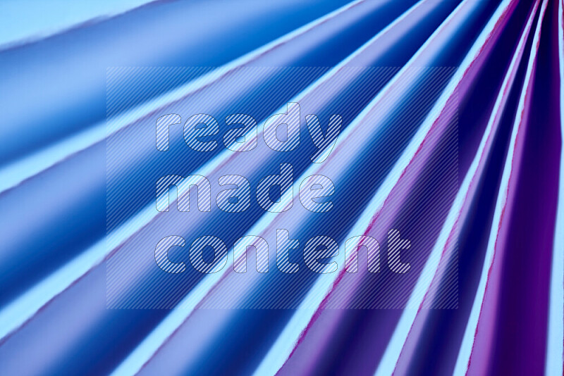 An image presenting an abstract paper pattern of lines in blue and pink tones