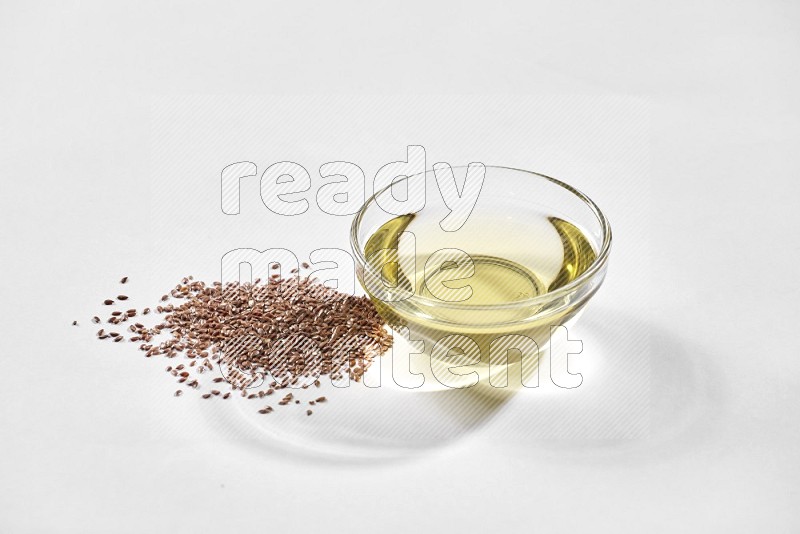 A glass bowl full of flax oil and flax seeds beside it on a white flooring in different angles