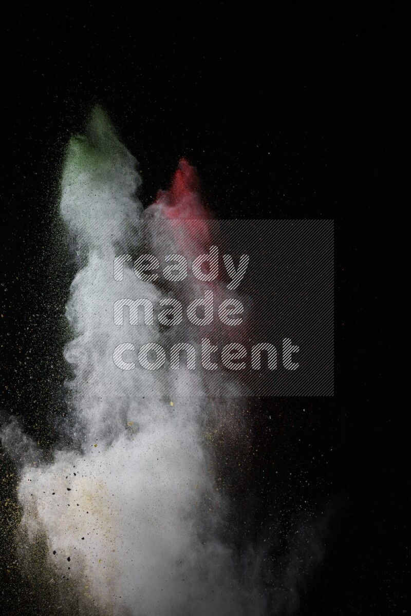 A side view of multicolored powder explosion on black background