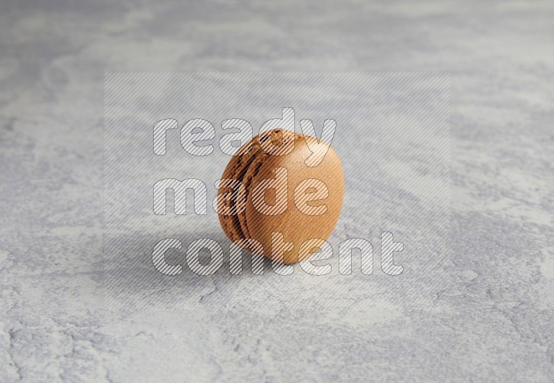45º Shot of Brown Coffee macaron on white  marble background
