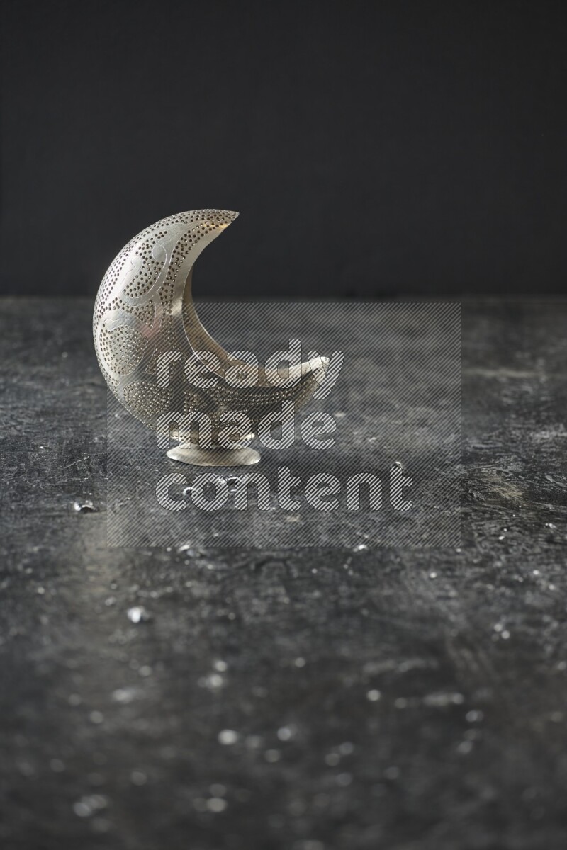 A lantern placed on a textured black background