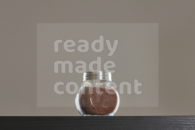Garden cress in a glass jar on black background