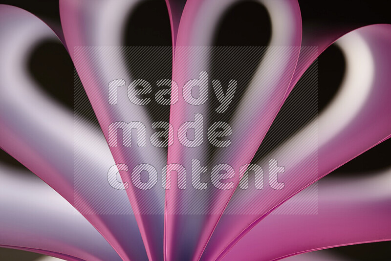 An abstract art piece displaying smooth curves in white and pink gradients created by colored light